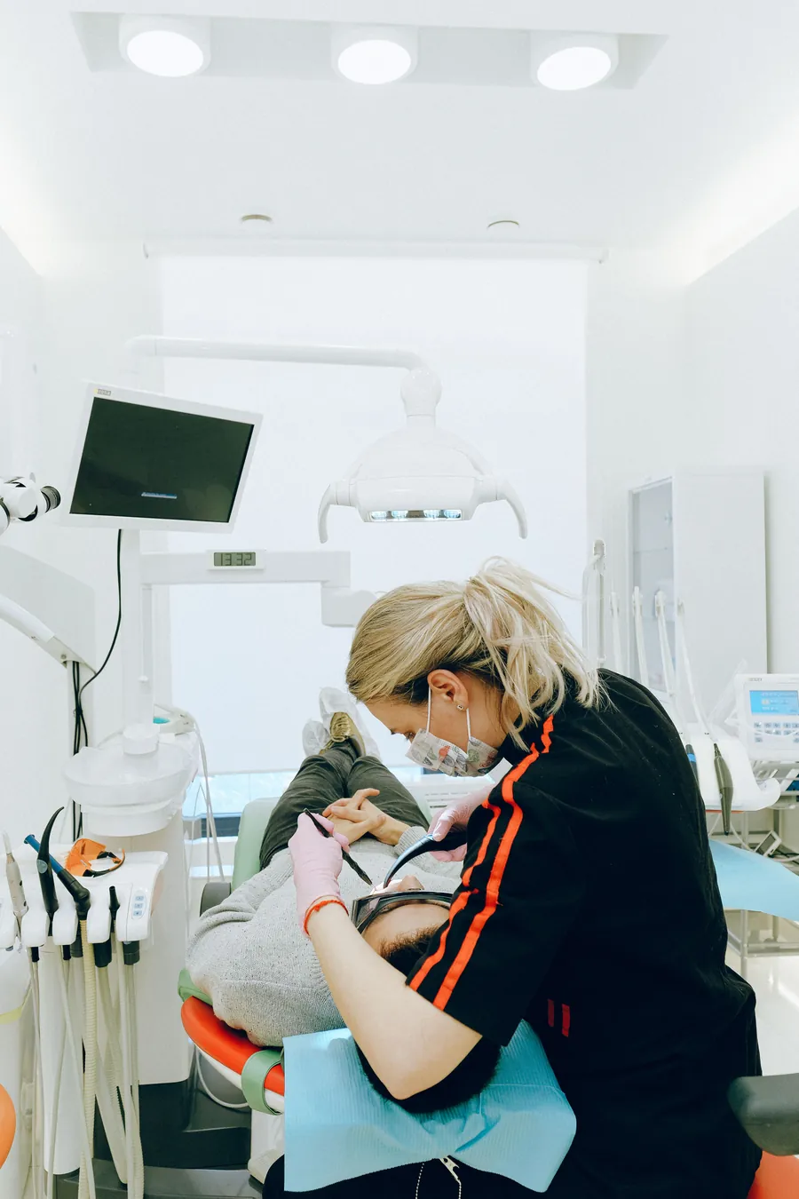 Dental specialist treating a patient in a bright, modern operatory
