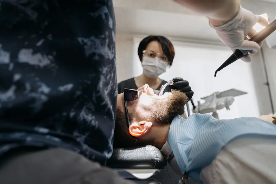 Dental professional performing an urgent dental procedure
