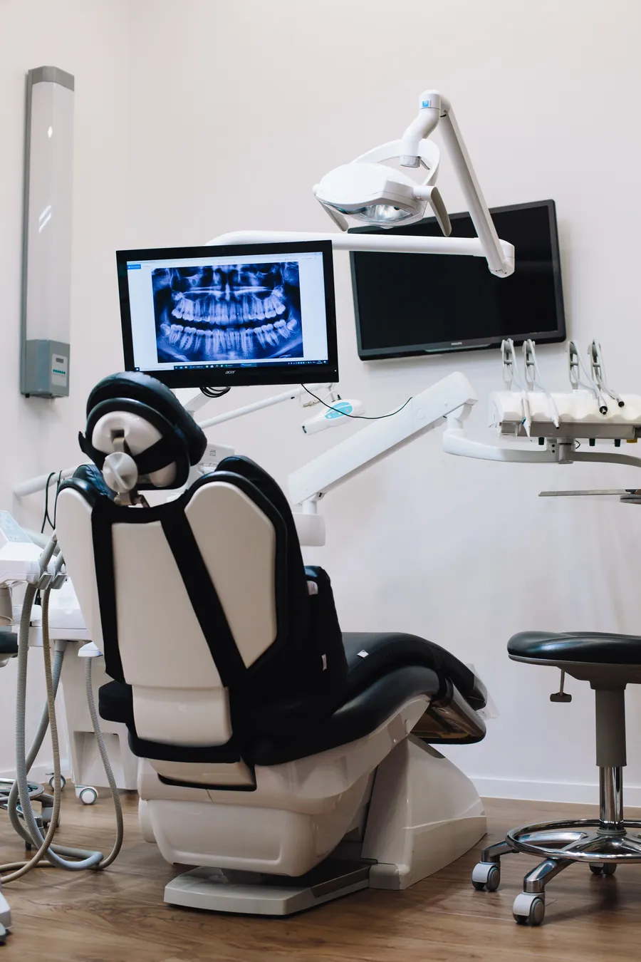 Dental operatory chair with a panoramic dental X-ray on the monitor