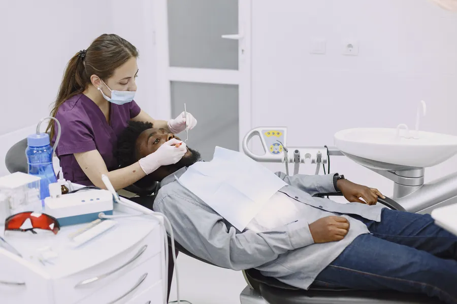Dental professional providing treatment to a patient